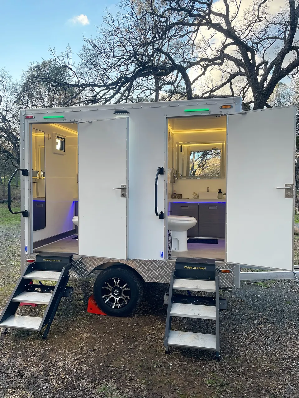 Restroom trailer with two illuminated entrances