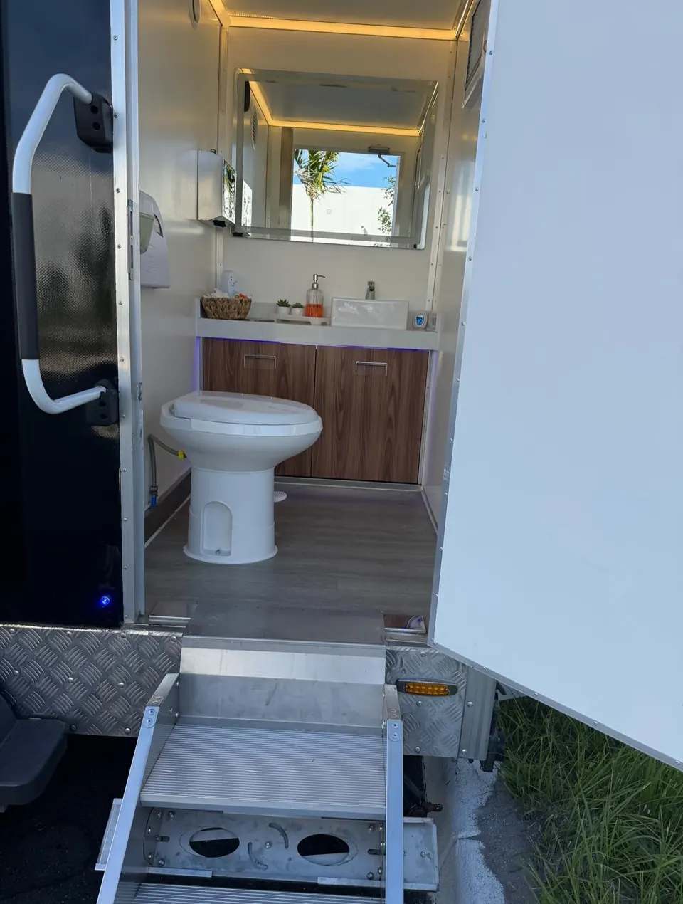 View through a restroom trailer doorway to the toilet